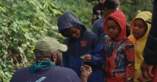 Kids learning forest science in the woods