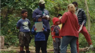 Students learning in the forest