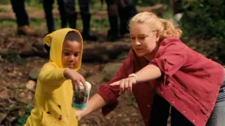 Student learning from instructor in the woods