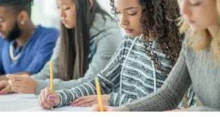 Students taking a test on paper in class