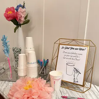 Stack of paper cups, on cup has the name Chappell written on it